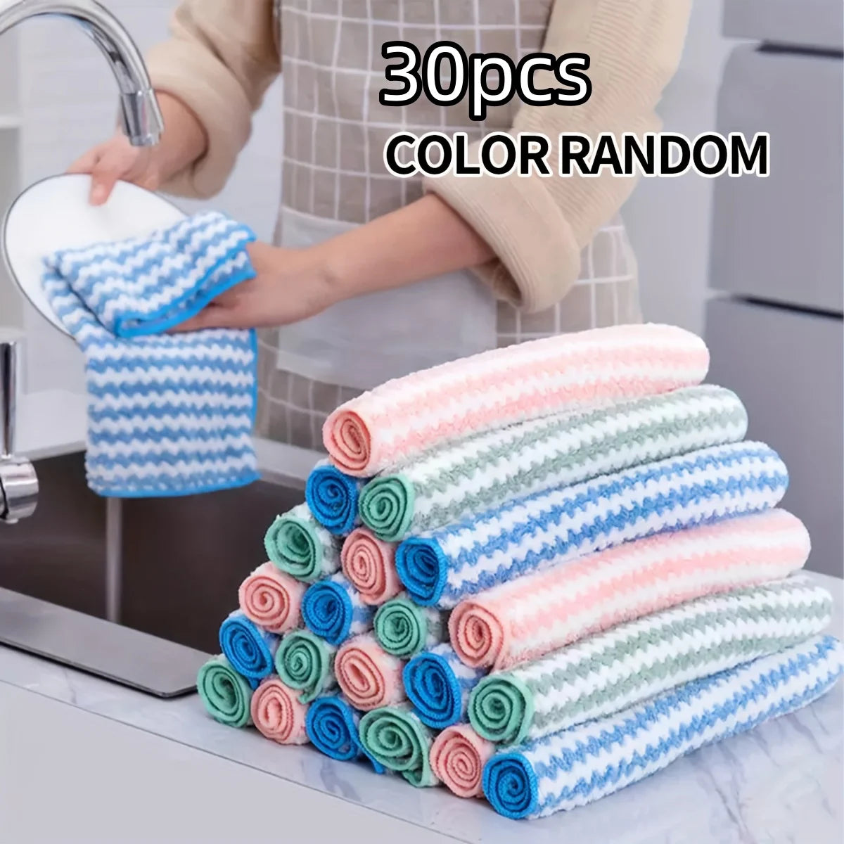 30 rolled dish cloths in assorted colors stacked by the sink