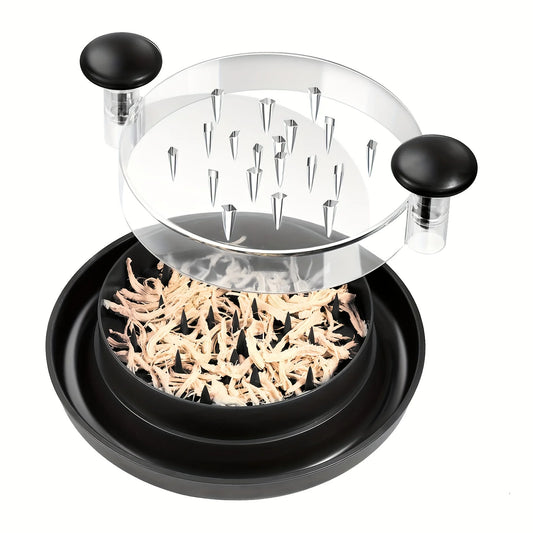Black chicken shredder with the clear spiked lid lifted above shredded chicken