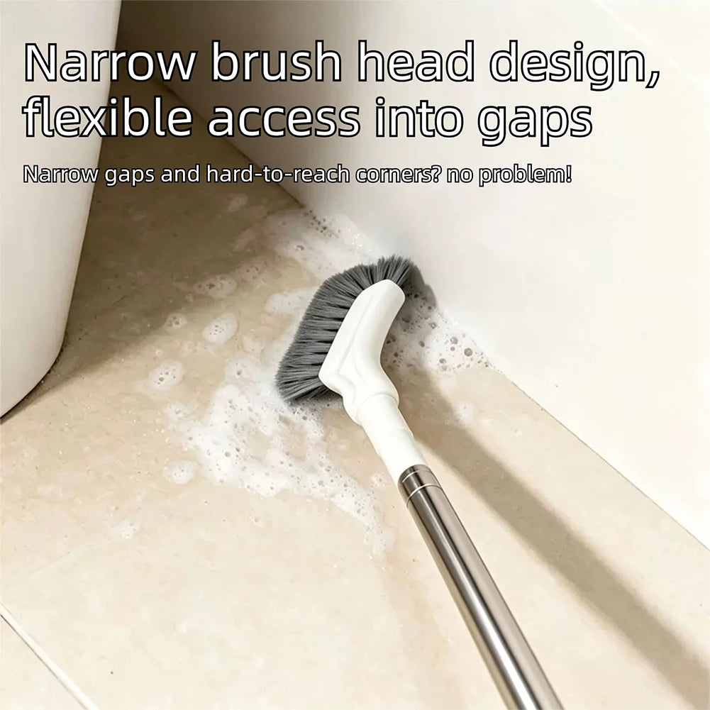 Extendable floor scrub brush reaching into the gap beside a toilet base