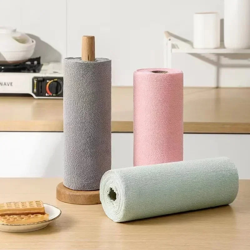 Gray roll on a wooden holder with pink and green rolls in a kitchen