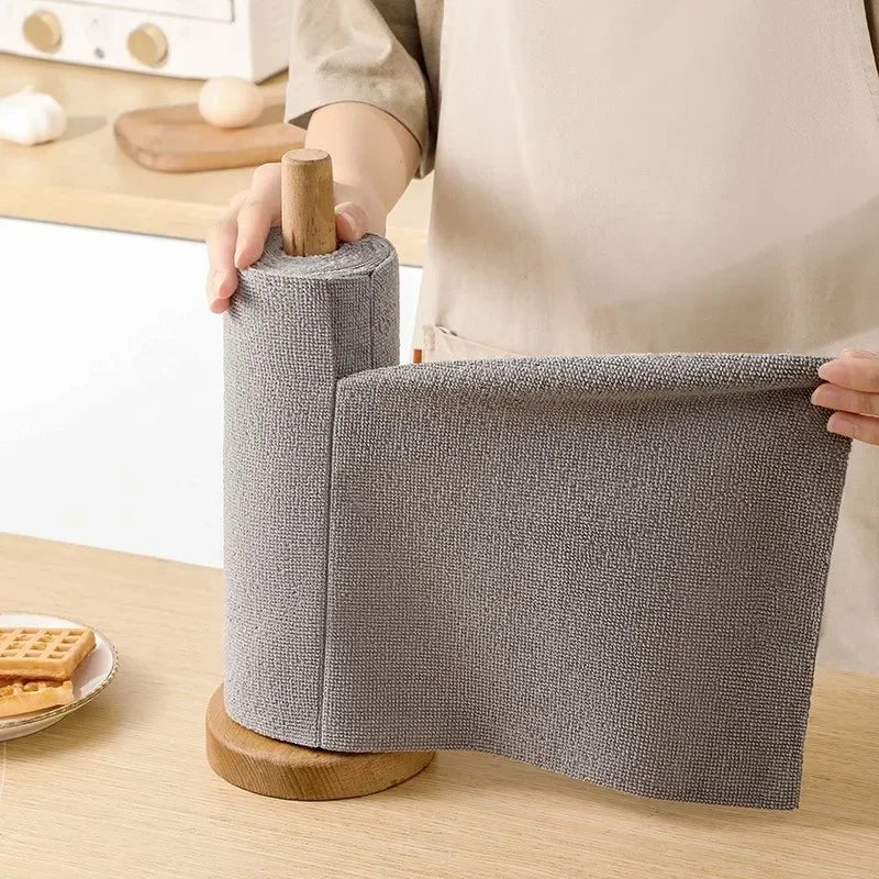 Pulling a sheet from a gray microfiber roll on a wooden holder