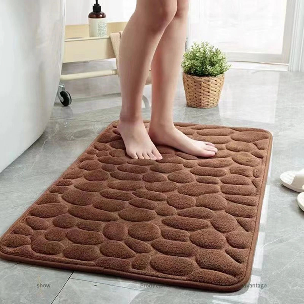Brown cobblestone bath mat on a bathroom floor
