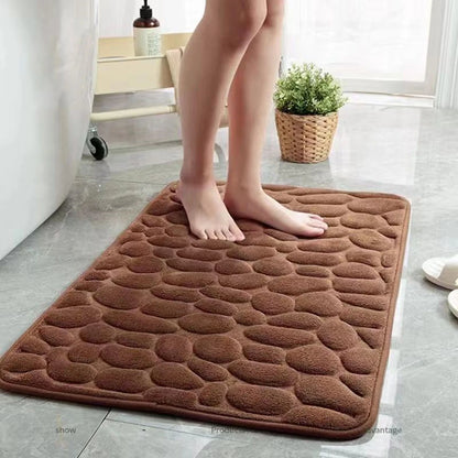Brown cobblestone bath mat on a bathroom floor