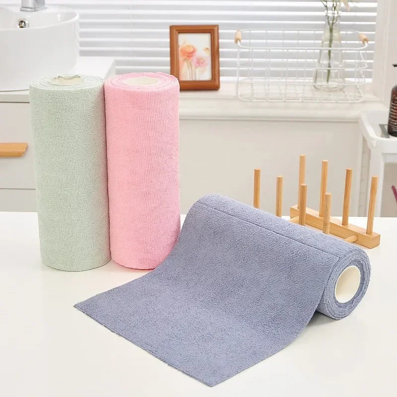Green, pink and blue microfiber towel rolls on a kitchen counter