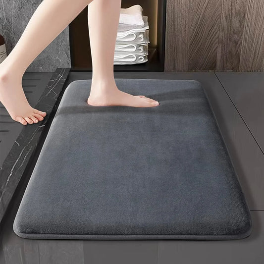 Gray super absorbent bath mat on a bathroom floor