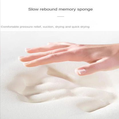 Hand pressing into the soft memory foam of the cobblestone bath mat