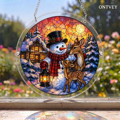 Lantern Snowman & Deer puzzle suncatcher hanging in a window with a garden behind it