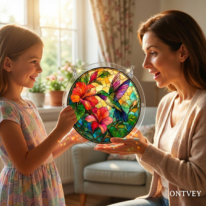 Mother and daughter holding the finished Hummingbird puzzle suncatcher