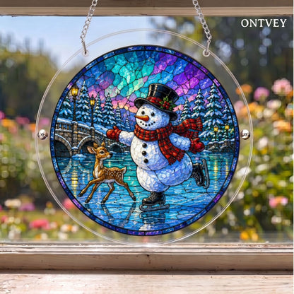 Skating Snowman & Deer puzzle suncatcher hanging in a window with a garden behind it